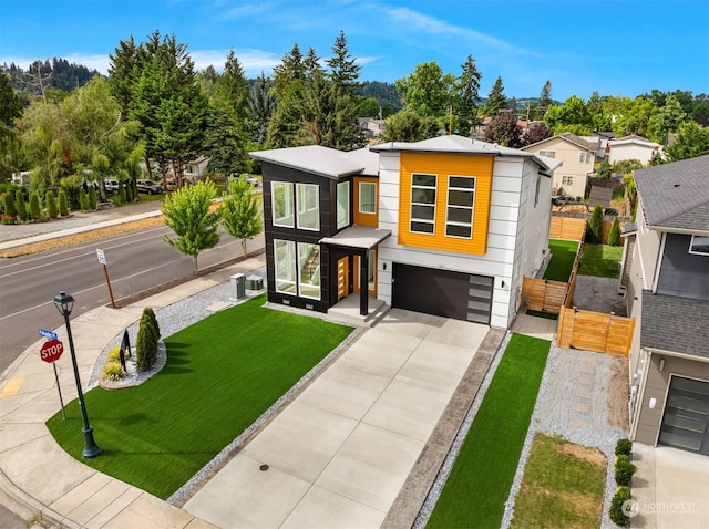 modern home featuring a garage and a front lawn