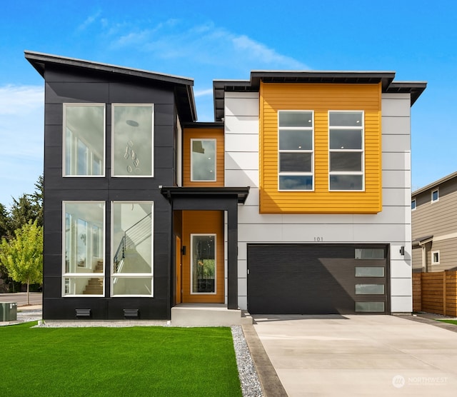 contemporary home featuring a garage, central air condition unit, and a front lawn