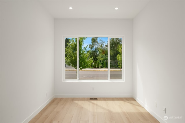 spare room featuring light wood-type flooring