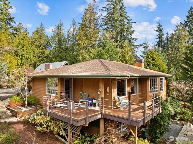 rear view of house with a wooden deck