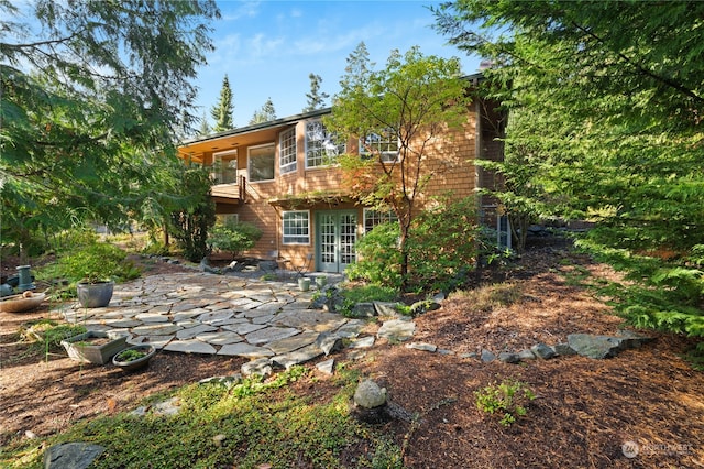 back of house with french doors, a patio, and a balcony