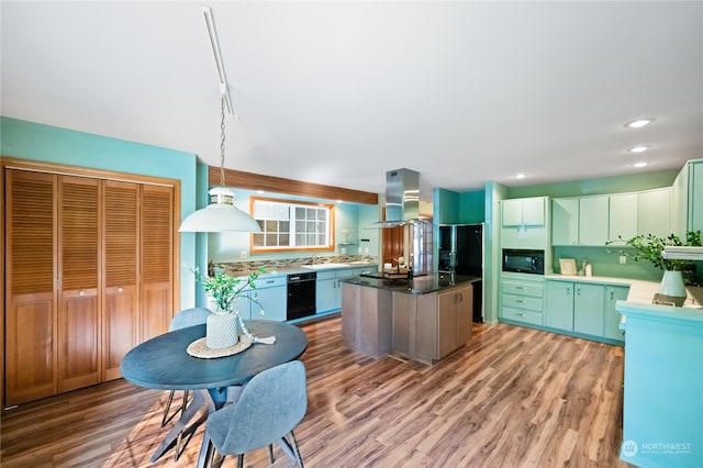 kitchen with black appliances, island exhaust hood, hardwood / wood-style flooring, and a center island