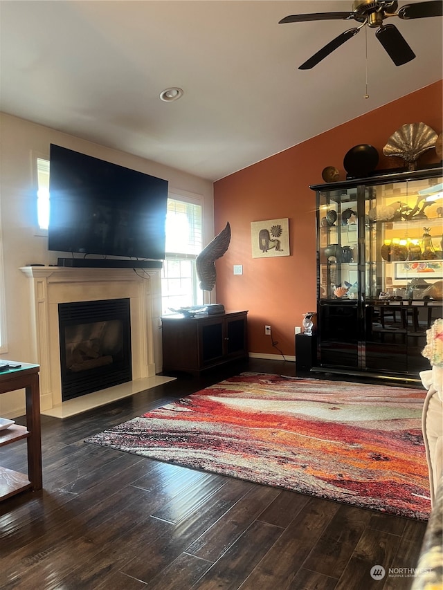 living room featuring hardwood / wood-style floors, vaulted ceiling, and ceiling fan