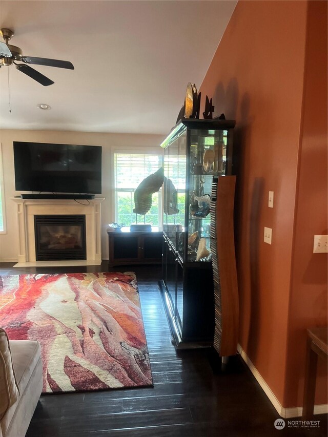 living room featuring hardwood / wood-style floors and ceiling fan