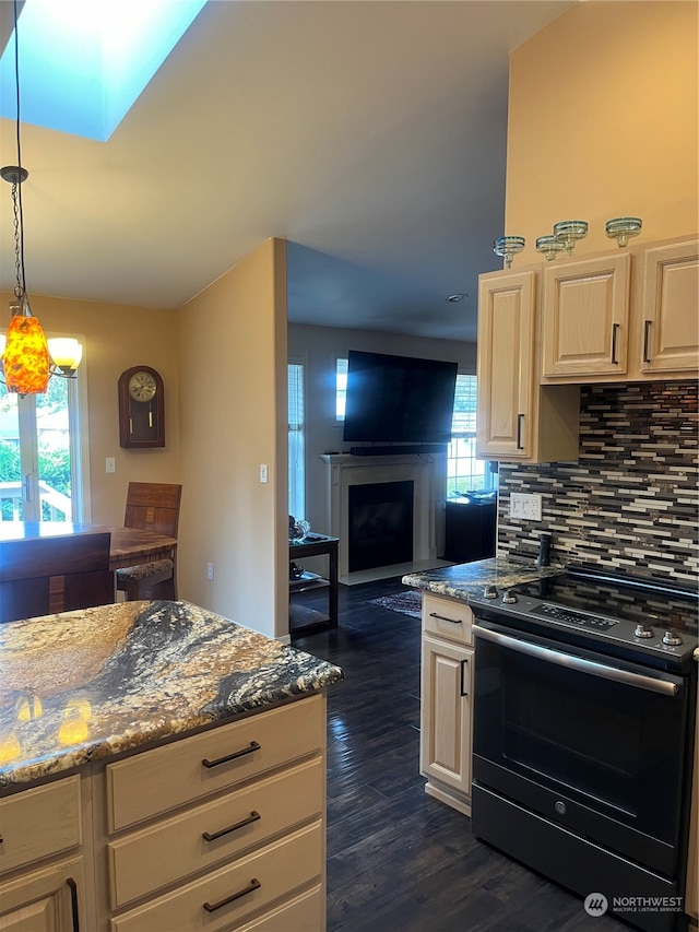 kitchen featuring decorative backsplash, dark hardwood / wood-style floors, a healthy amount of sunlight, and black range with electric stovetop