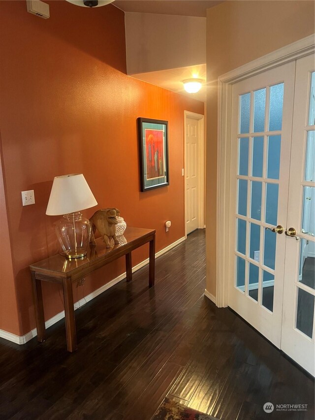 hall with dark wood-type flooring and french doors