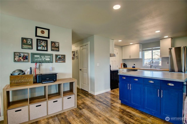 kitchen with blue cabinetry, sink, white cabinetry, dark hardwood / wood-style flooring, and dishwasher