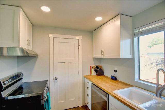 kitchen featuring white cabinetry, sink, stainless steel appliances, and butcher block counters