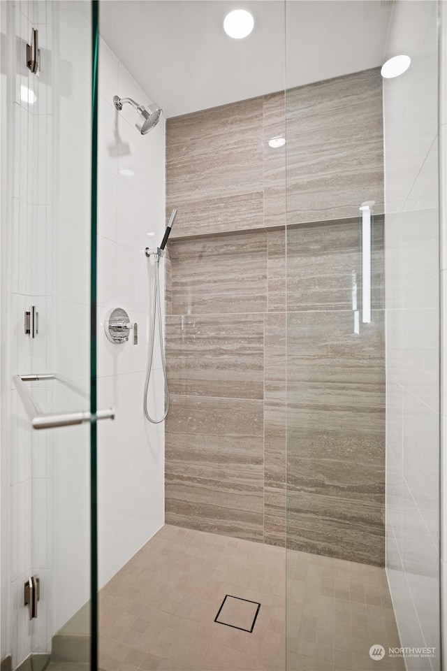 bathroom with a shower with shower door