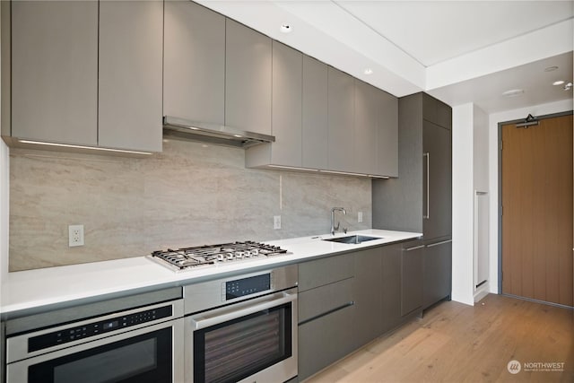 kitchen featuring gray cabinets, appliances with stainless steel finishes, and sink