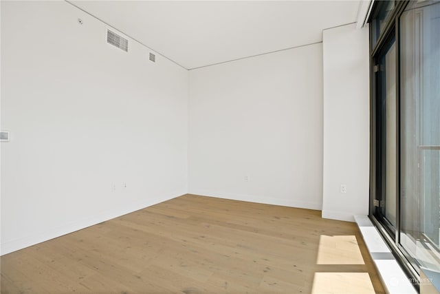 unfurnished room with light hardwood / wood-style floors