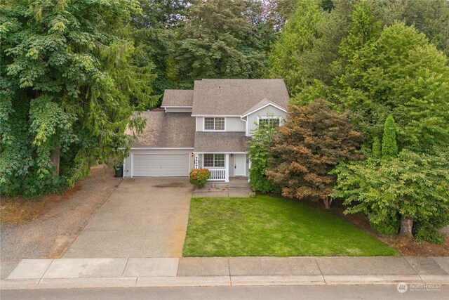 view of front of home featuring a front yard and a garage