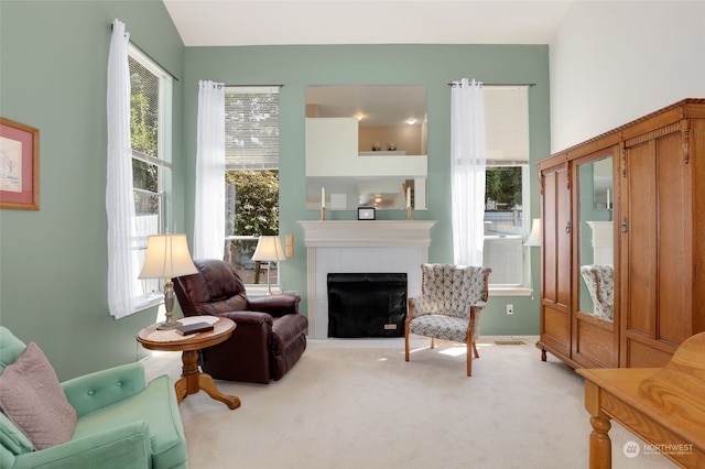 sitting room featuring carpet flooring, a fireplace, and vaulted ceiling