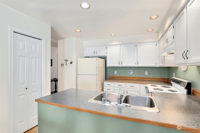 kitchen with white cabinetry, white appliances, sink, and kitchen peninsula