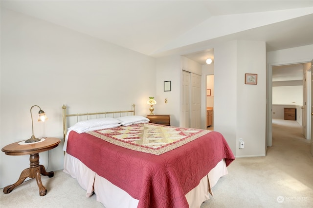 carpeted bedroom featuring a closet and lofted ceiling