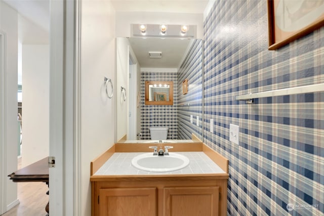 bathroom featuring tile walls, toilet, and vanity