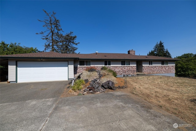 single story home with brick siding, driveway, a garage, and a chimney