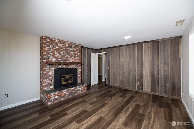 unfurnished living room featuring baseboards and wood finished floors
