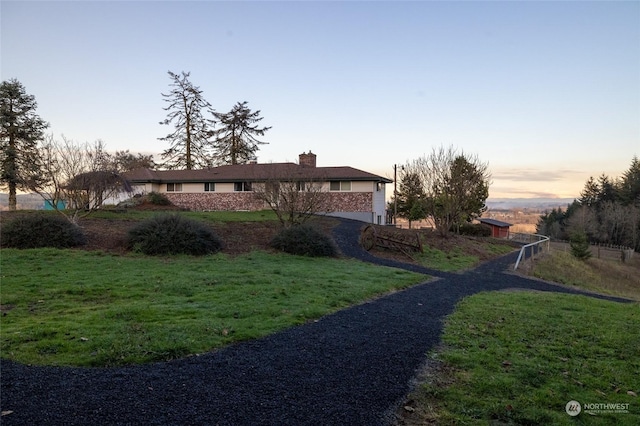 exterior space with a lawn and a chimney