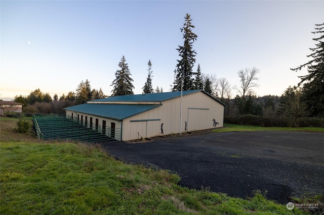 outdoor structure at dusk with an outbuilding and an outdoor structure