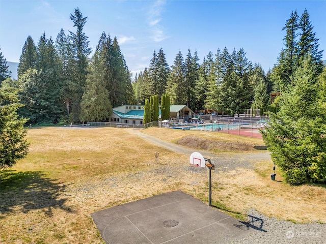 view of yard with basketball hoop