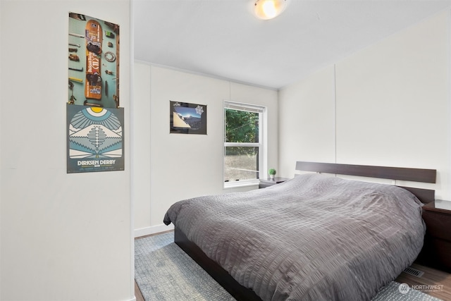 bedroom with hardwood / wood-style floors