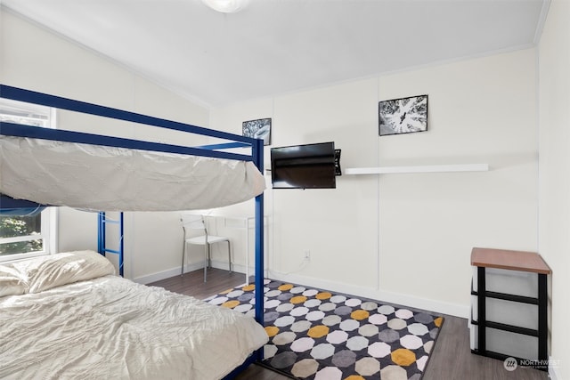 bedroom with vaulted ceiling and dark wood-type flooring