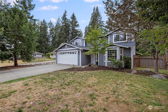 traditional-style house featuring a garage, driveway, a front lawn, and fence