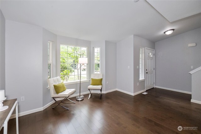 entrance foyer with dark wood-style floors and baseboards