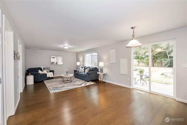 living room featuring baseboards and dark wood finished floors