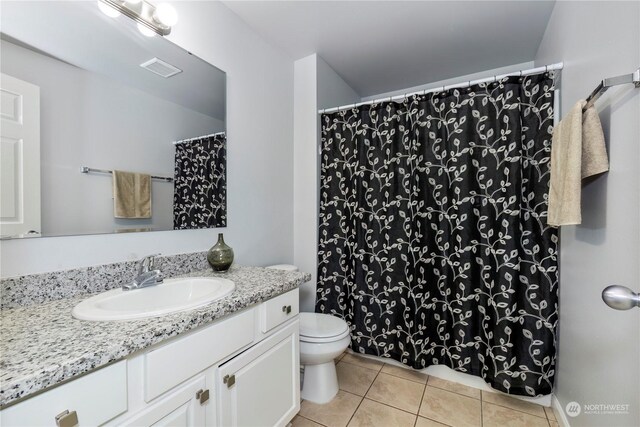 full bath with toilet, vanity, visible vents, and tile patterned floors