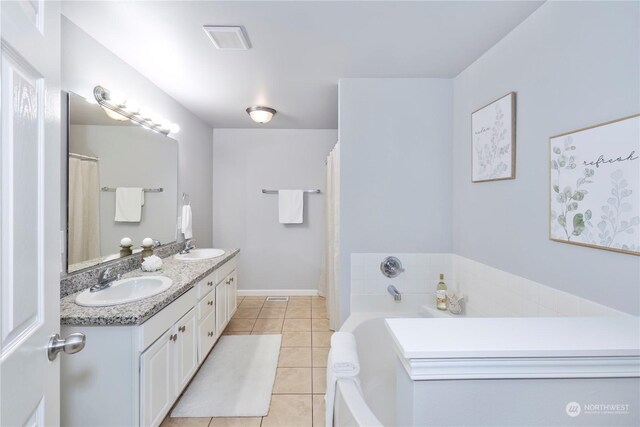 bathroom featuring double vanity, visible vents, a sink, and tile patterned floors