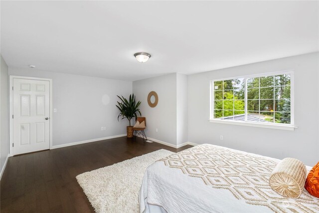 bedroom featuring dark wood-type flooring and baseboards