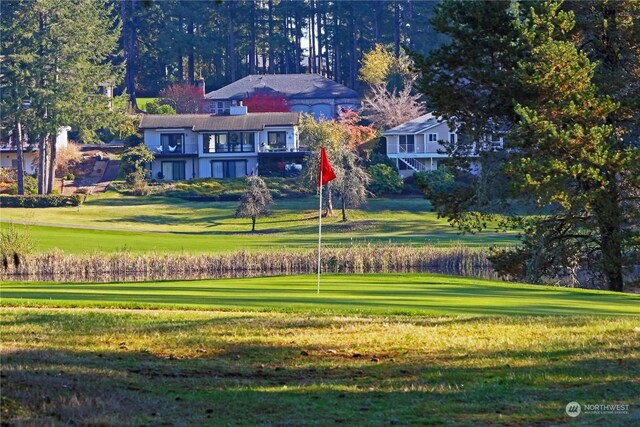 view of home's community with a yard