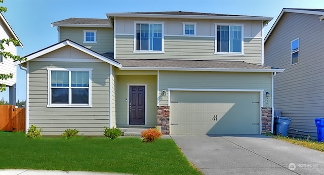 view of front facade featuring a garage and a front yard