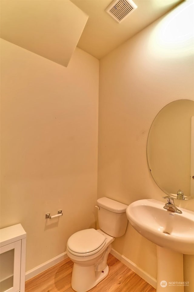 bathroom featuring hardwood / wood-style floors, sink, and toilet