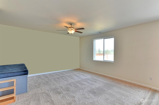 carpeted empty room featuring ceiling fan