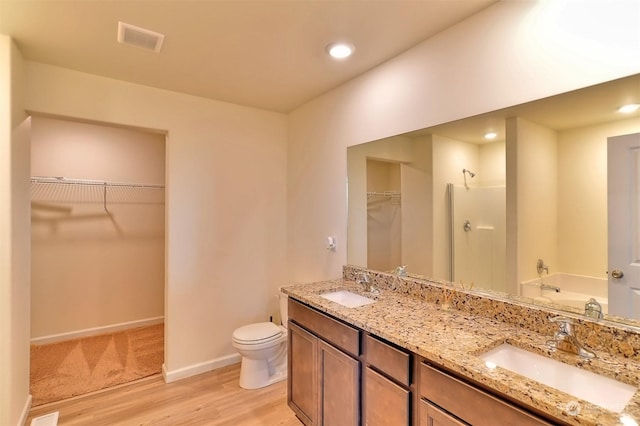 full bathroom with vanity, hardwood / wood-style floors, plus walk in shower, and toilet