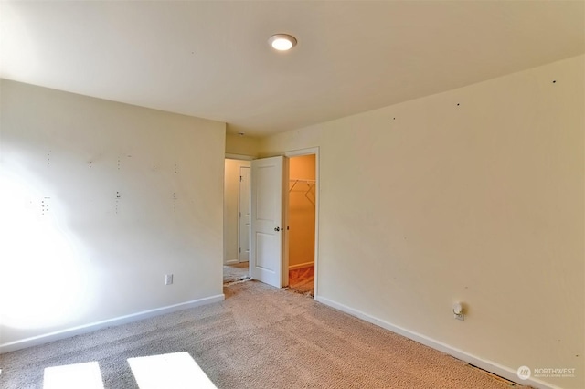 unfurnished room featuring light colored carpet