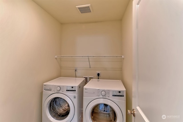 clothes washing area featuring washing machine and clothes dryer