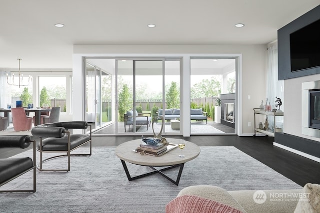 living room with a notable chandelier and dark hardwood / wood-style floors