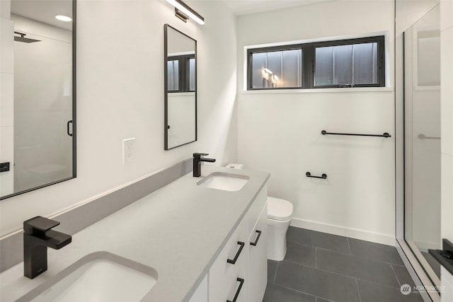 bathroom with vanity, tile patterned floors, a shower with door, and toilet