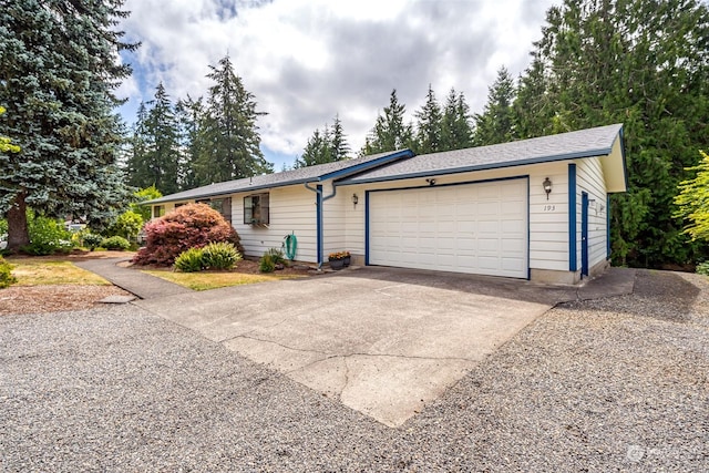 single story home featuring a garage and driveway