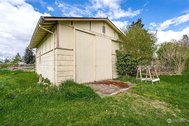 view of outdoor structure with a lawn