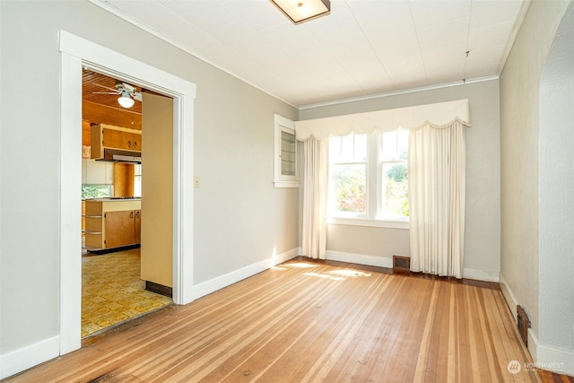 spare room featuring ornamental molding and hardwood / wood-style floors