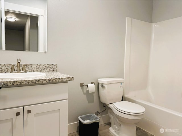 full bathroom with vanity, shower / bathing tub combination, wood-type flooring, and toilet