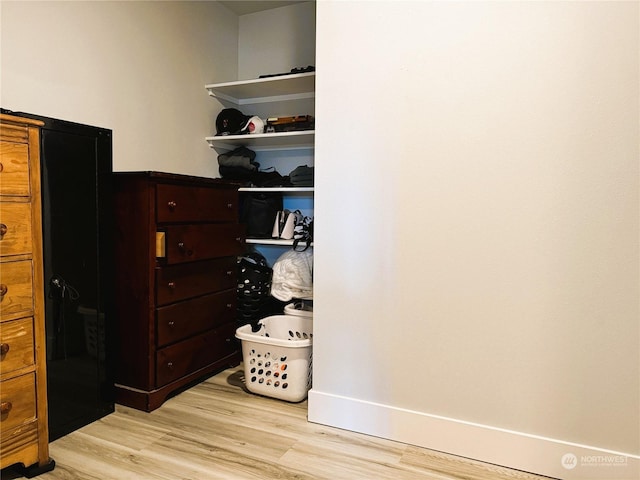 walk in closet with light wood-type flooring