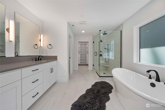 bathroom featuring vanity and separate shower and tub