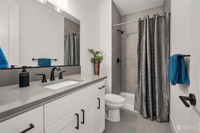 bathroom featuring vanity, a shower with shower curtain, tile patterned floors, and toilet