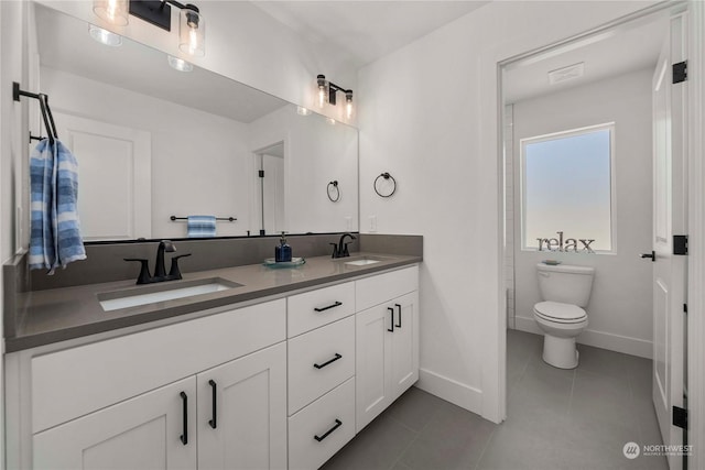 bathroom featuring tile patterned flooring, vanity, and toilet